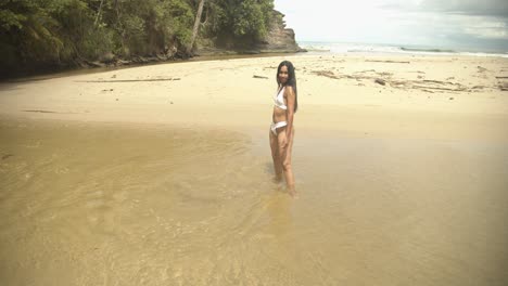 A-girl-walks-in-a-river-with-clear-water-at-her-feet-while-wearing-a-translucent-bikini-which-leaves-the-mind-with-nothing-to-think-about