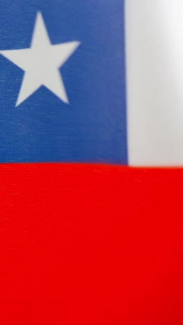 Vertical video of chilean national flag waving by the wind