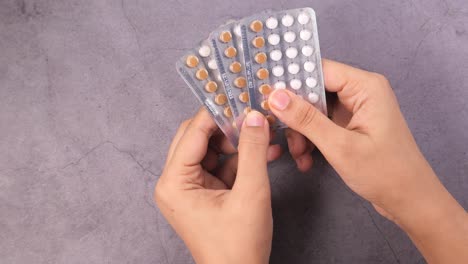 woman holding birth control pills