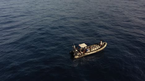 a small single boat is floating outside the coast of madeira