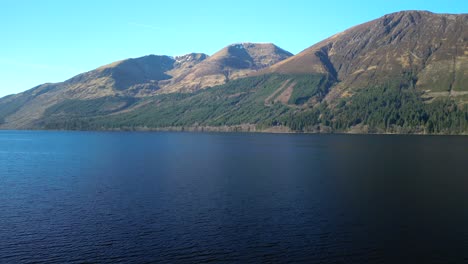 rise up over dark lake with mountains at loch lochy scottish highlands