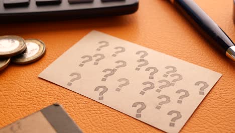 high angle view of question mark on paper on office desk