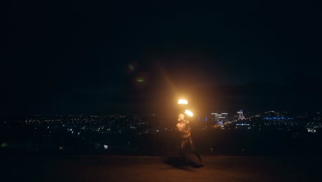 clip begins with nobody in sight camera captures young man doing fire dance with two torches