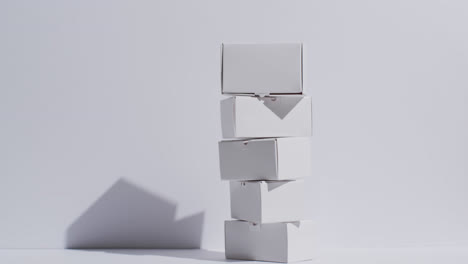 video of stacked cardboard boxes with copy space over white background