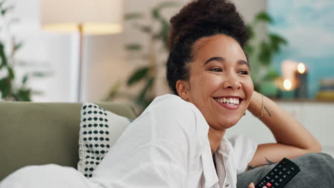 woman relaxing on couch and watching tv