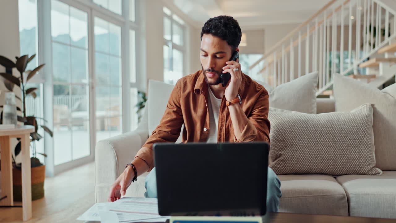 Man working from home with laptop and phone