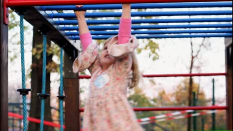 a cute little girl exercise on monkey bars-1