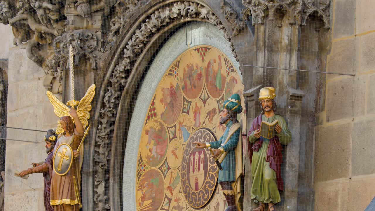 Close-up of moving statues on Prague’s medieval astronomical clock, daylight, steady camera, detailed architecture