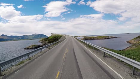 driving a car on a road in norway atlantic ocean road or the atlantic road (atlanterhavsveien) been awarded the title as (norwegian construction of the century).