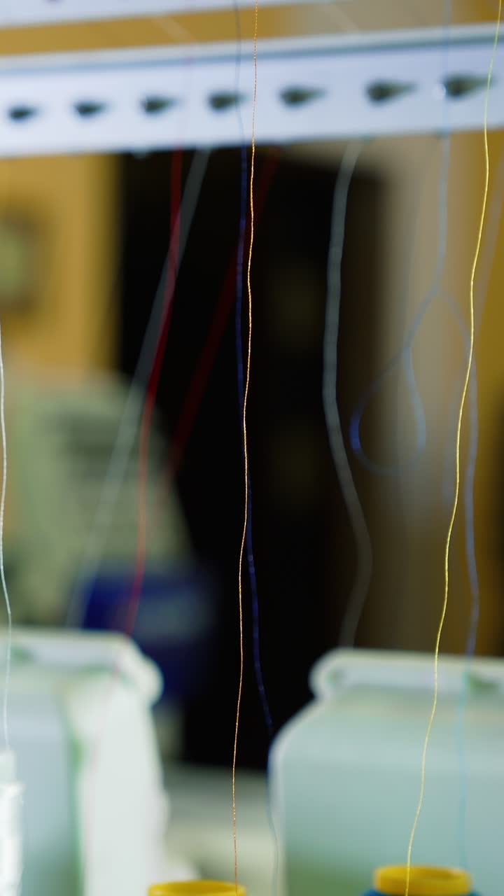 Different parts of sewing machine. Tailoring loom with rotating sewing reels. Vertical video