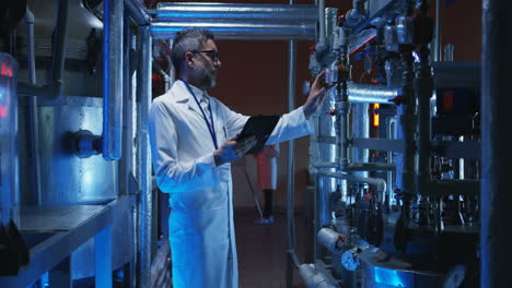 scientists inspecting industrial machinery