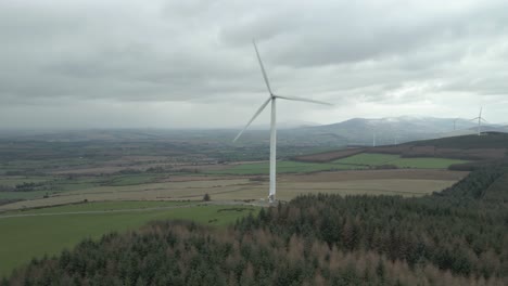 Wind-Farm-Against-Cloudy-Sky-In-County-Wexford,-Ireland---aerial-shot