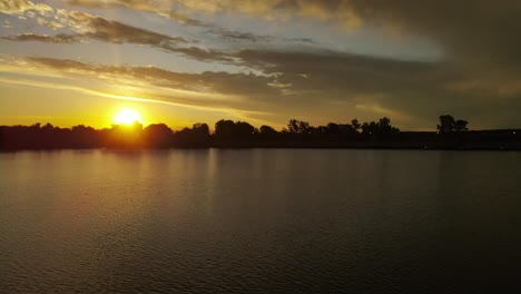 mesmerizing view of sun setting below horizon at the river