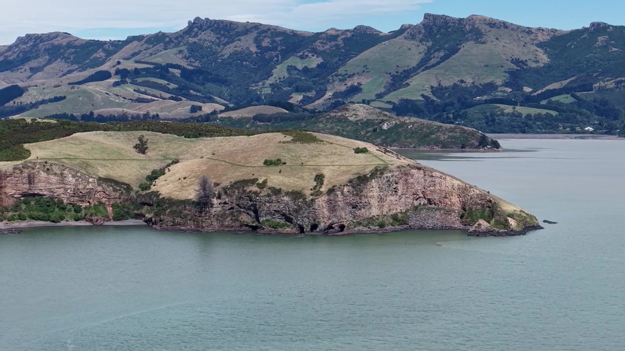 Ripresa aerea di Quail Island che mostra le formazioni rocciose vulcaniche all'estremità settentrionale (Lyttelton Harbour, Christchurch, Nuova Zelanda)