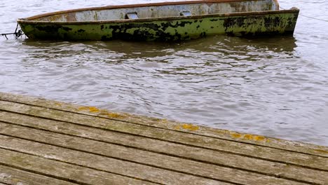 an old rowing boat is moored in the harbor