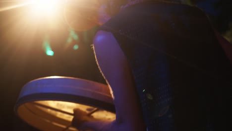 slowmotion shot of a performer banging a drum at a resort in corfu, greece