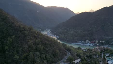 beautiful sunrise behind the mountains and ganga river flowing in rishikesh done sunrise hyper lapse view in india