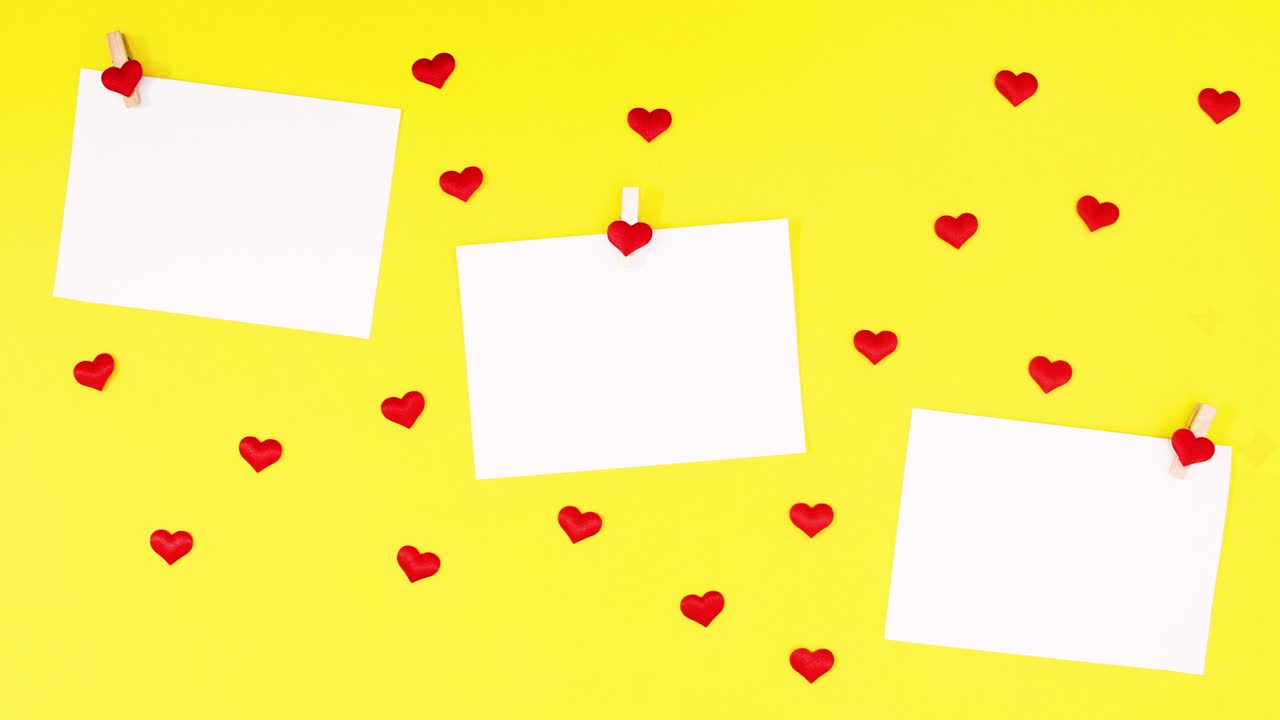 Fogli per testo e cuori appaiono su sfondo giallo. Stop motion di San Valentino
