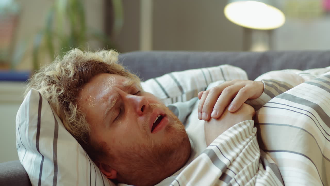 Feverish Man Coughing and Drinking Water