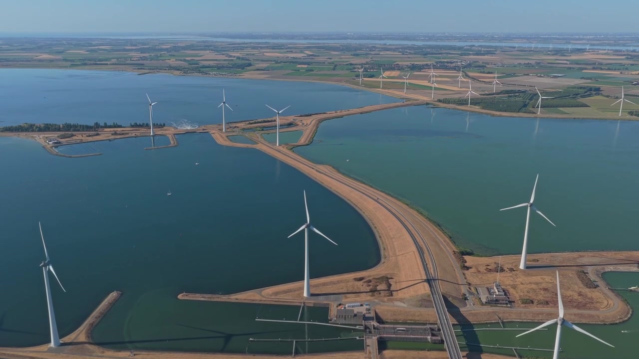 Aerial View of Wind Turbines Along a Coastal Causeway