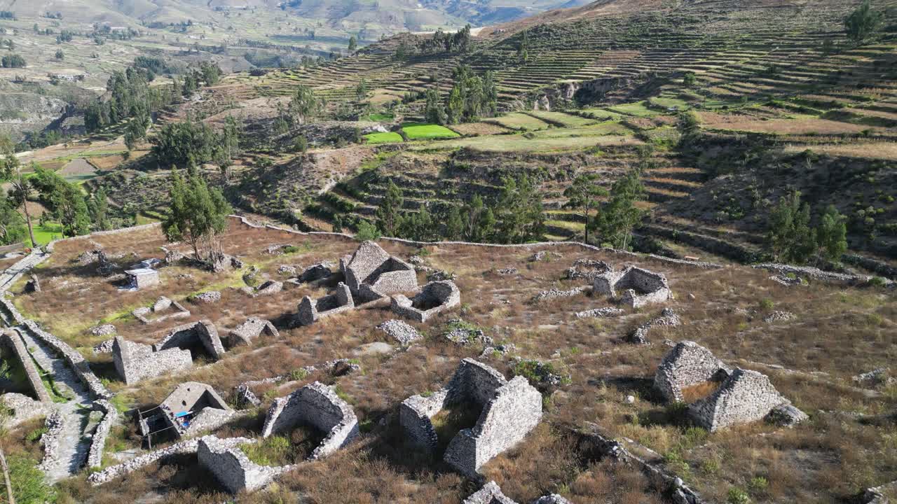 Flyover Uyo Uyo ruins toward terraced agriculture hillsides beyond