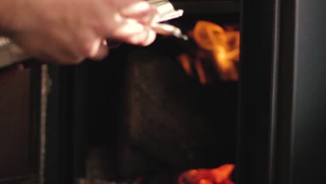 A-guy-reading-a-book-in-front-of-the-fire-place