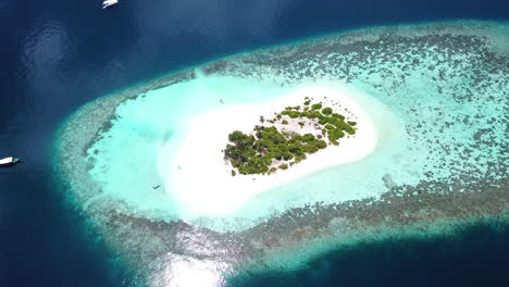 revealing drone shot of small island in the maldives