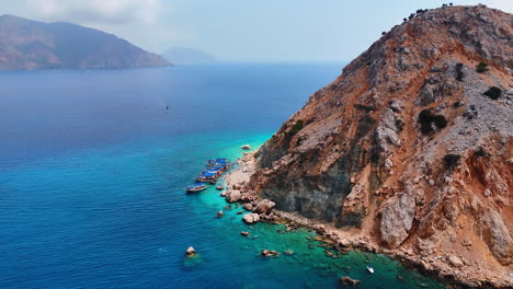 approaching the row of boats standing on anchor near the rocks. view on the suluada island in the turkey mediterranean