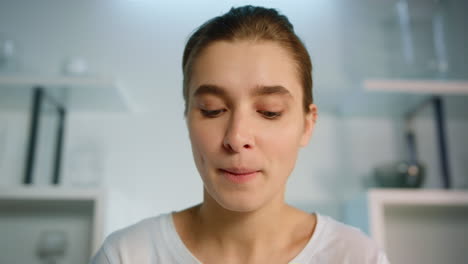 smiling woman looking webcam using computer closeup. app user typing chatting