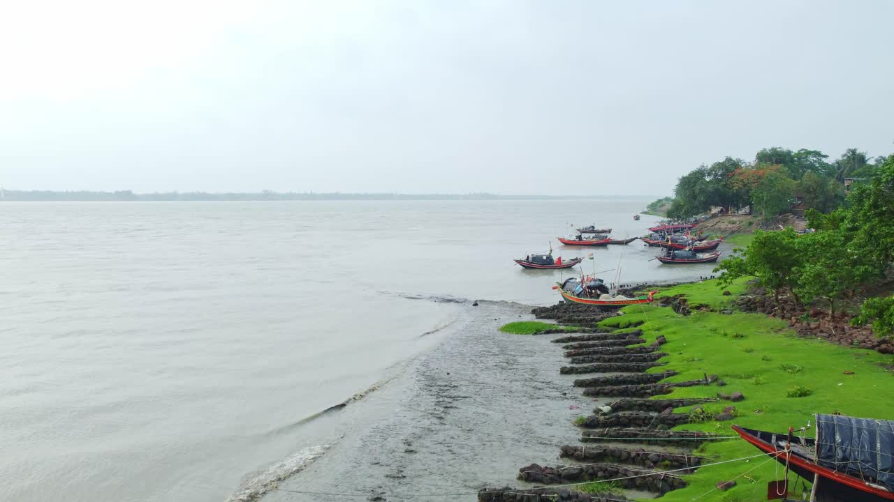 Boats docked along a tranquil riverbank
