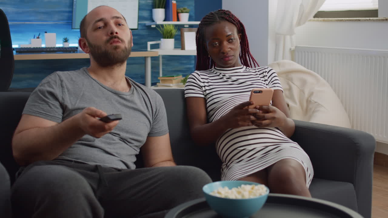 Modern interracial family expecting child using technology