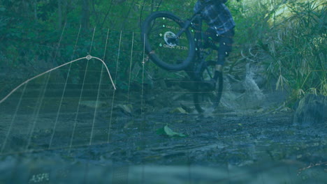 man riding mountain bike through creek, showing stock market percentage charts floating overhead