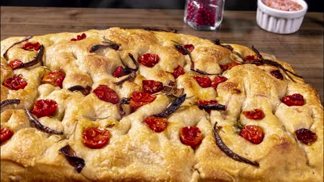 traditional italian focaccia with pepperoni, cherry tomatoes, black olives, rosemary ando onion - homemade flat bread focaccia