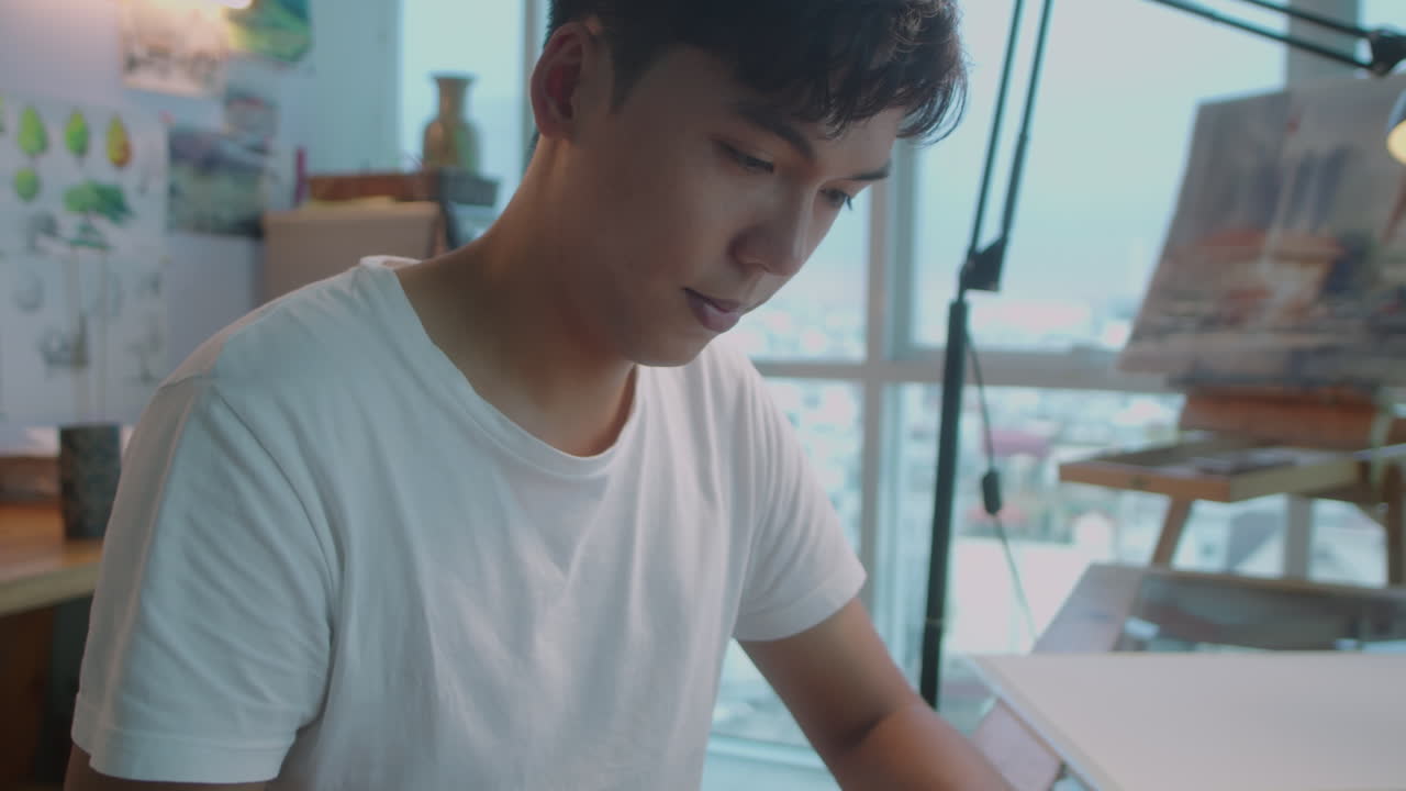 Asian Artist Drawing Sketch at Desk