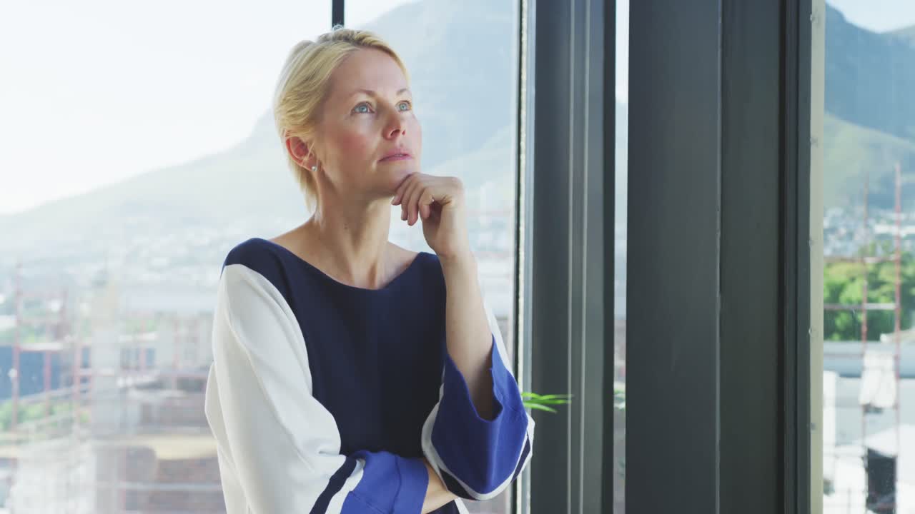 Business woman thoughtful looking through the window