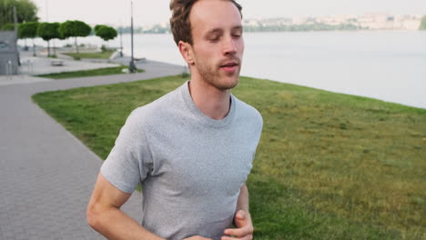 young man running in the city near a river 1