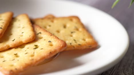 crispy herbed crackers on a white plate