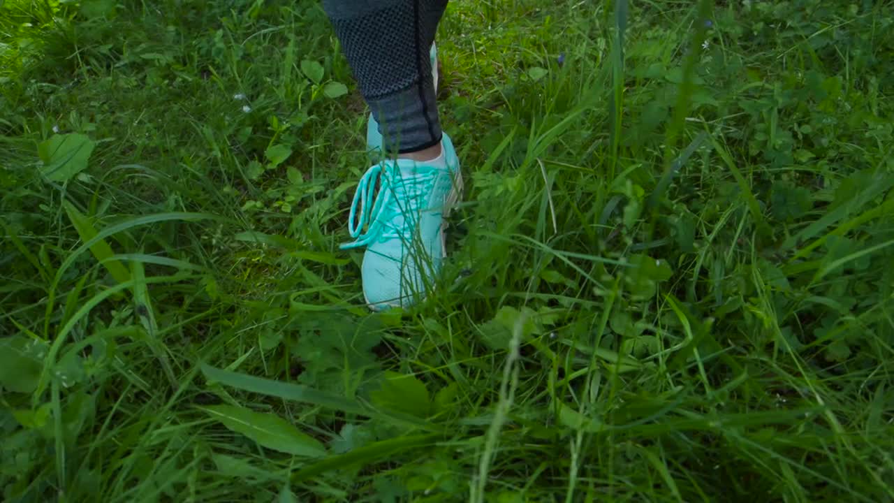 Woman Walking Through Grassy Area