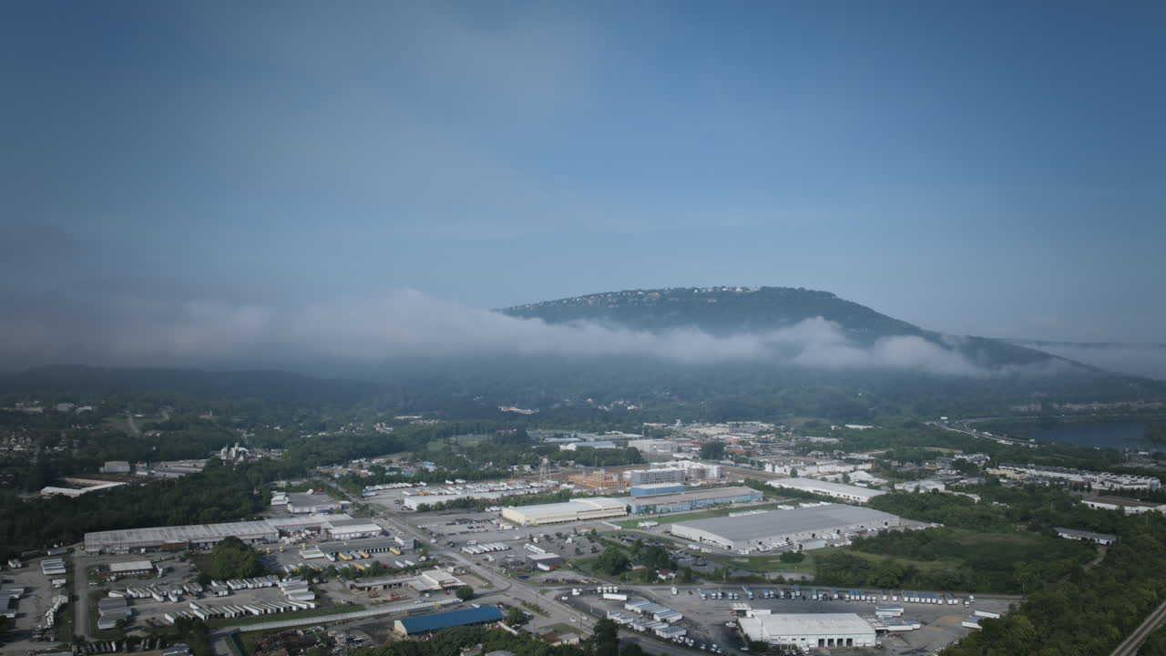 Fast aerial hyperlapse in the daytime flying towards Lookout Mountain in Chattanooga, Tennessee with clouds surrounding it