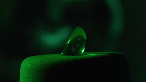 close-up of a contact lens under green light