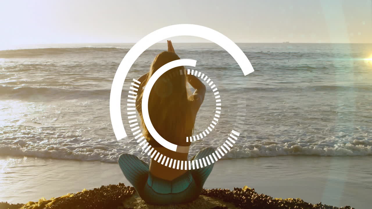 Sitting on beach, woman with circular animation overlaying ocean view
