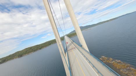 fpv flight over bomla bridge in norway over spissøysundet between the islands of nautøy in stord municipality and spissøy