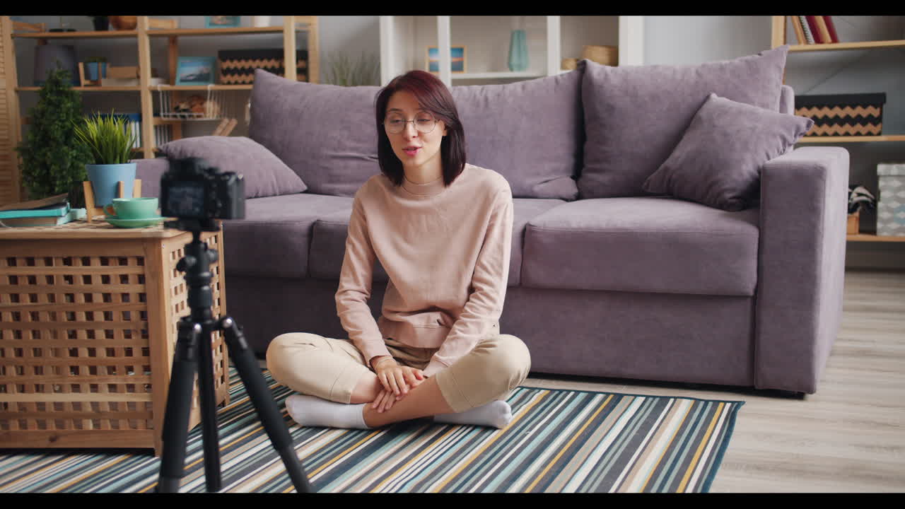 Woman creating a video blog at home