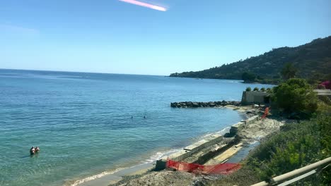 blue sea and coastline of italy from a train traveling to menton in france