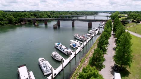 aerial pullout savannah river at augusta georgia with boats and american flag flapping in the breeze