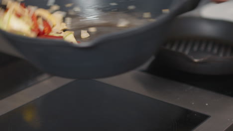 tossed multicolored vegetables in wok pan