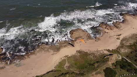 Drone-over-a-paraglider-on-the-beach-of-Le-Pedrera-Uruguay