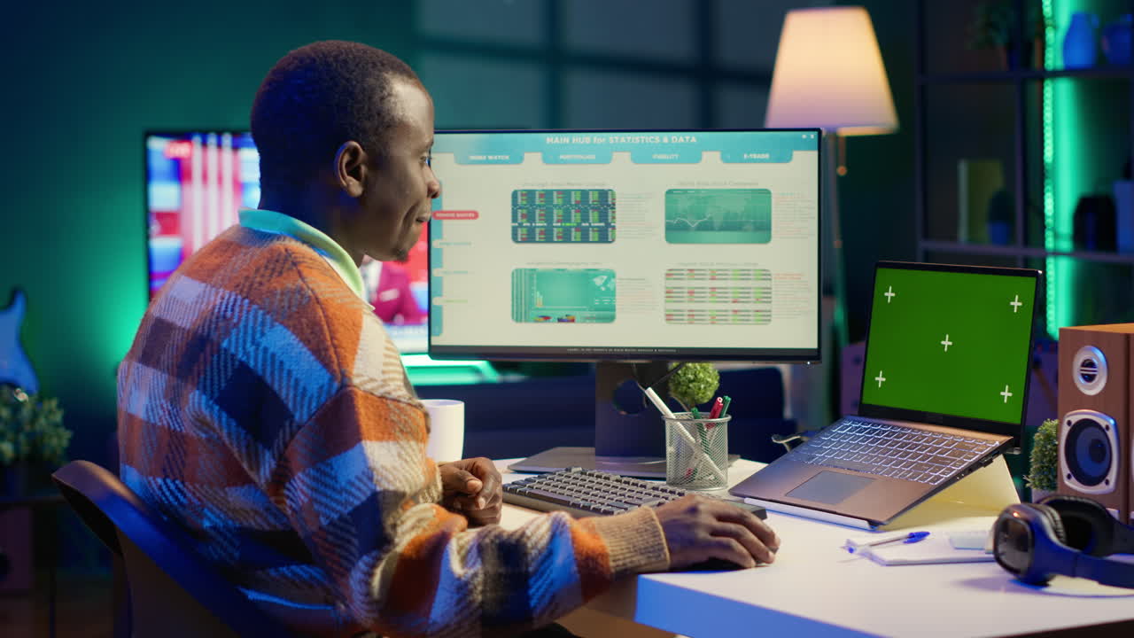 A man working on a computer with financial data on the screen