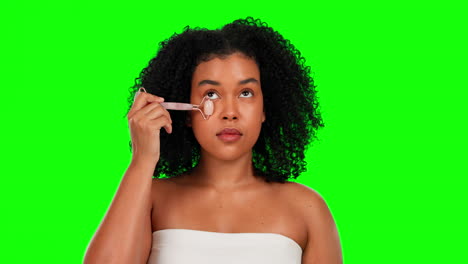 woman, beauty and skincare with roller on green
