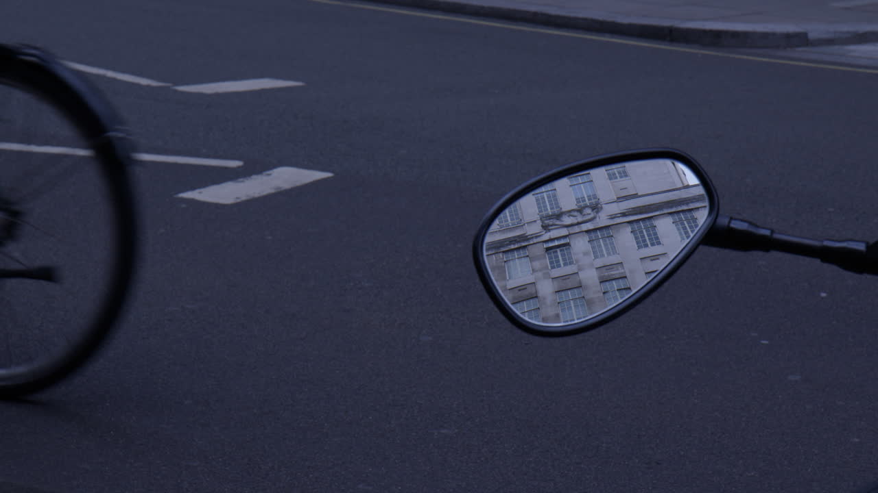 A Motorcycle Mirror Reflects a Historic Building in London - Close Up